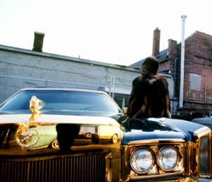 Isaac Hayes with his custom Cadillac behind the Stax Records building.