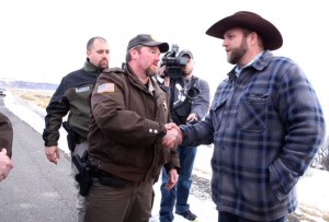 Sheriff and militia leader shake hands